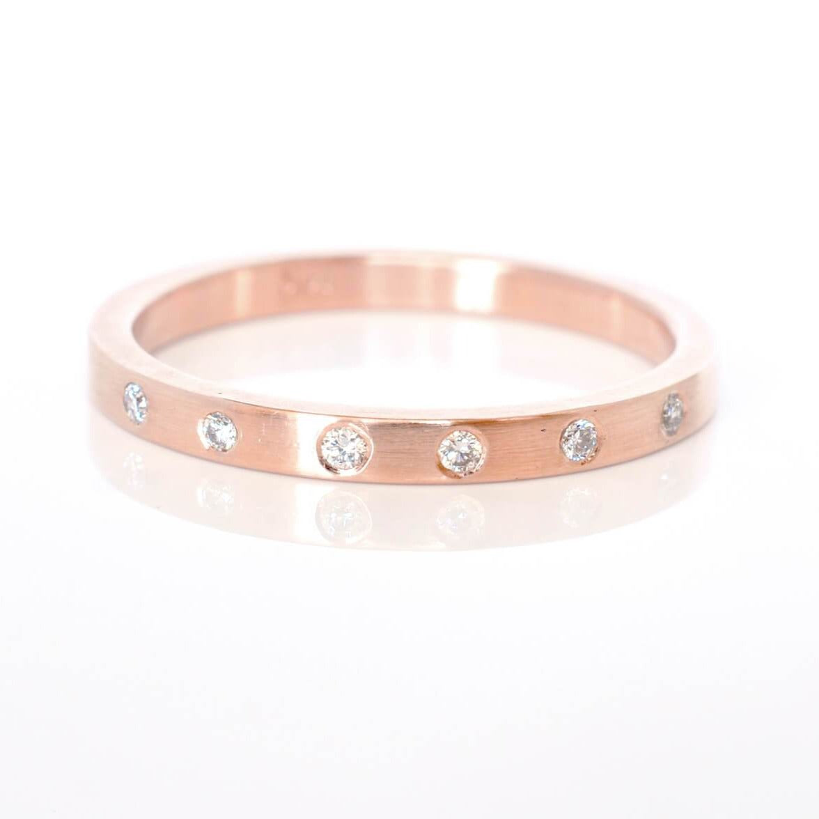 14k red gold eternity band with Canadian mined white diamonds.