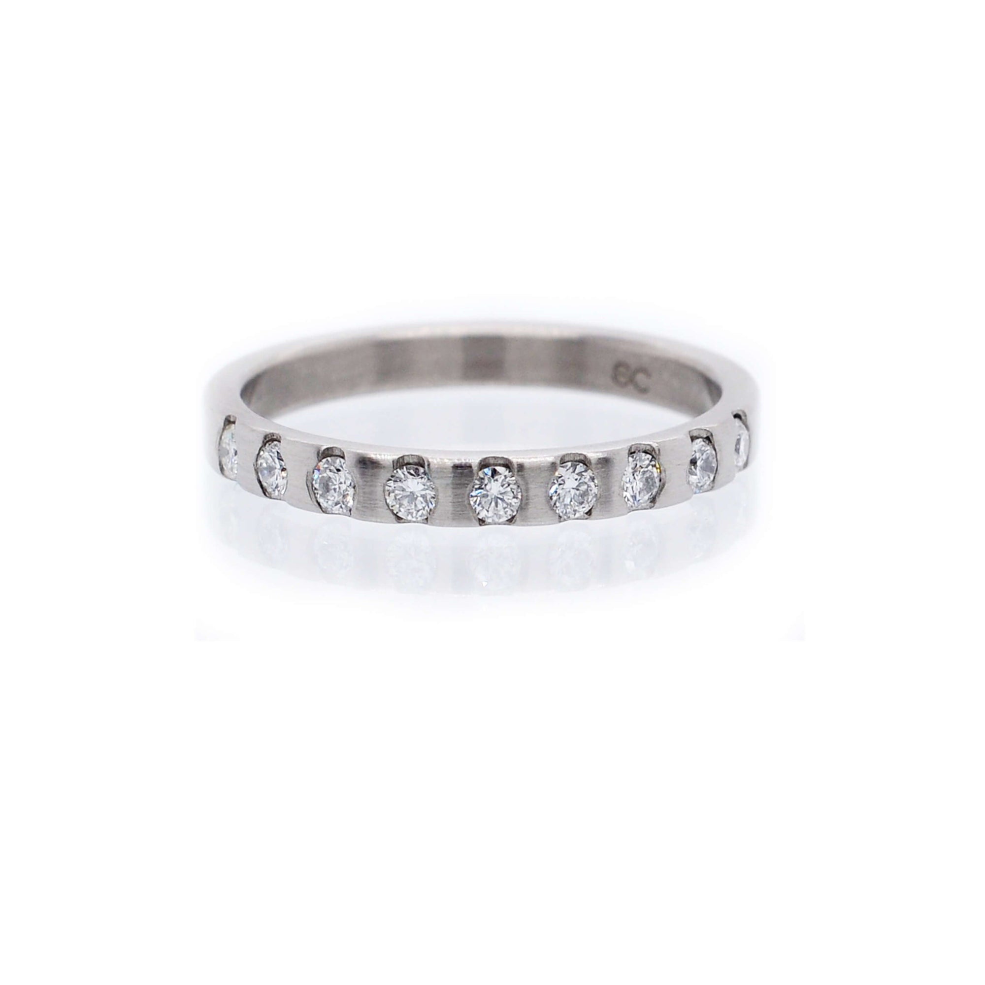 Diamond and palladium half eternity band made from recycled metal and conflict-free stones. Handmade by EC Design Jewelry in Minneapolis, MN.