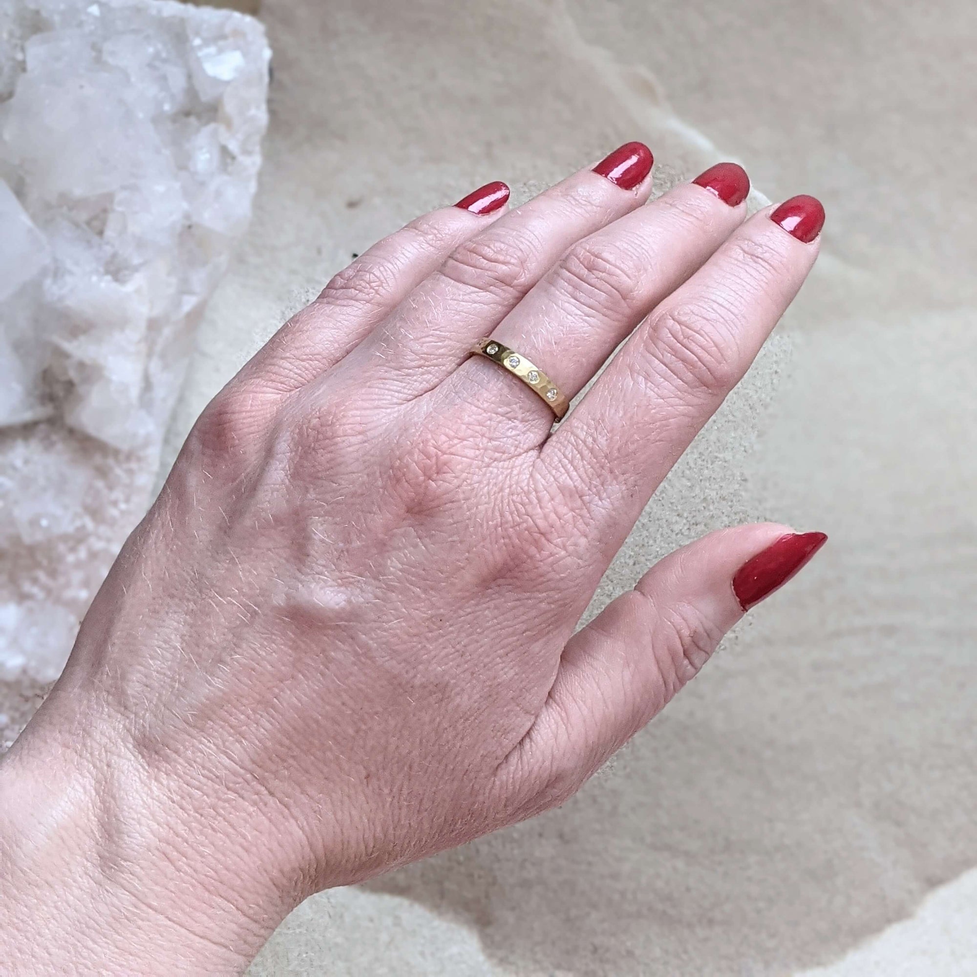 Handmade hammered 18k yellow gold eternity band with Canadian mined white diamonds. Made by EC Design Studio in Minneapolis, MN using recycled metal and conflict-free stones.