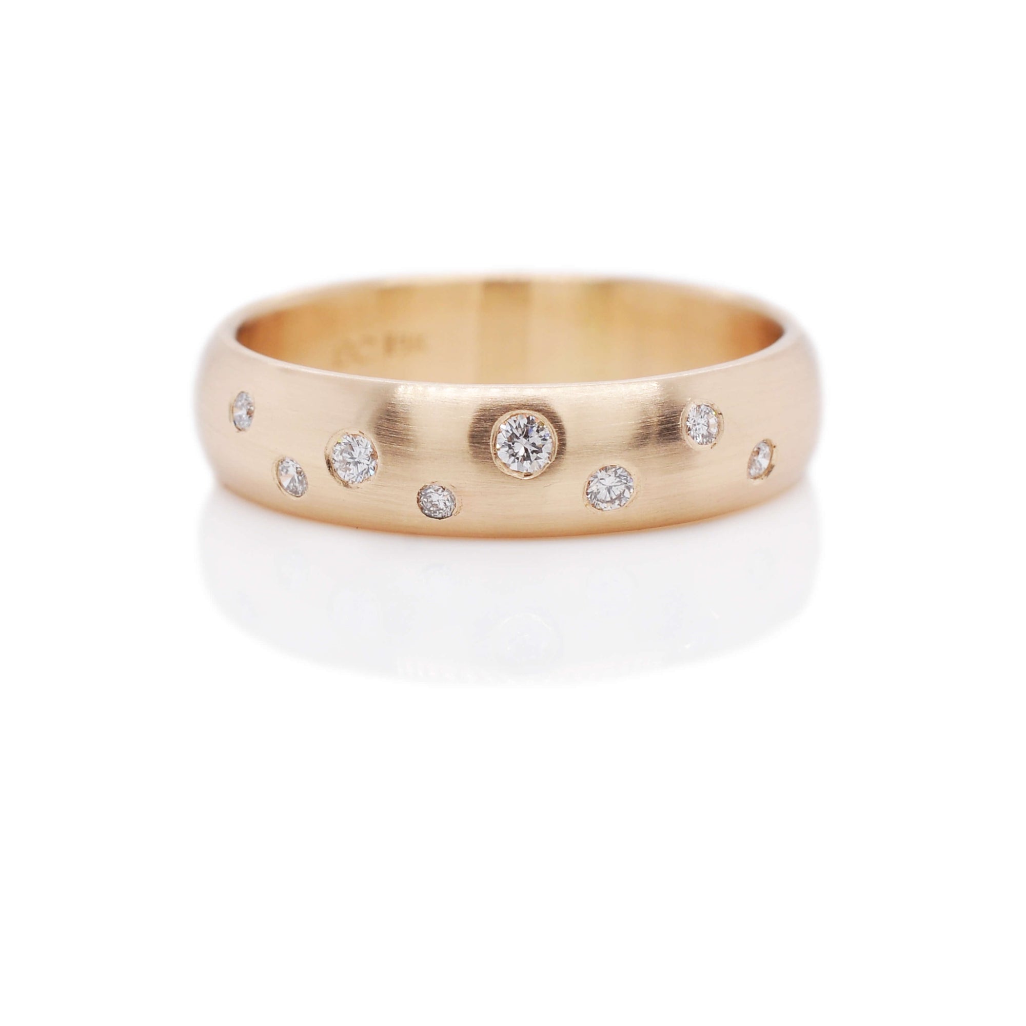Yellow gold low dome ring with flush set white diamonds. Handmade by EC Design Jewelry in Minneapolis, MN using recycled metal and conflict-free stones.