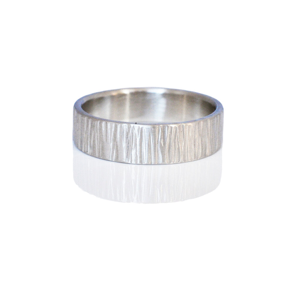 6mm linear hammered band of platinum. Handmade in Minneapolis, MN by EC Design Jewelry using recycled metals.