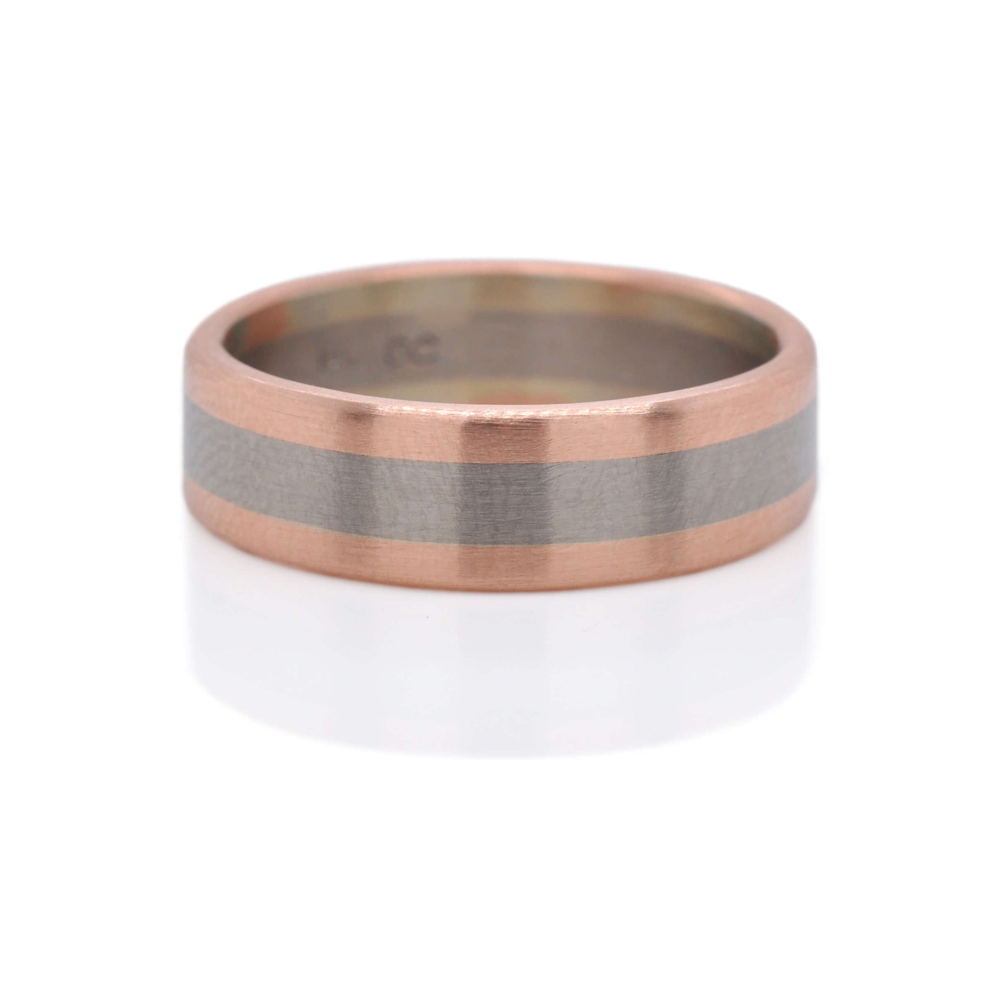 Satin finished rose gold and palladium wedding band. Handmade by EC Design Jewelry in Minneapolis, MN using recycled gold.