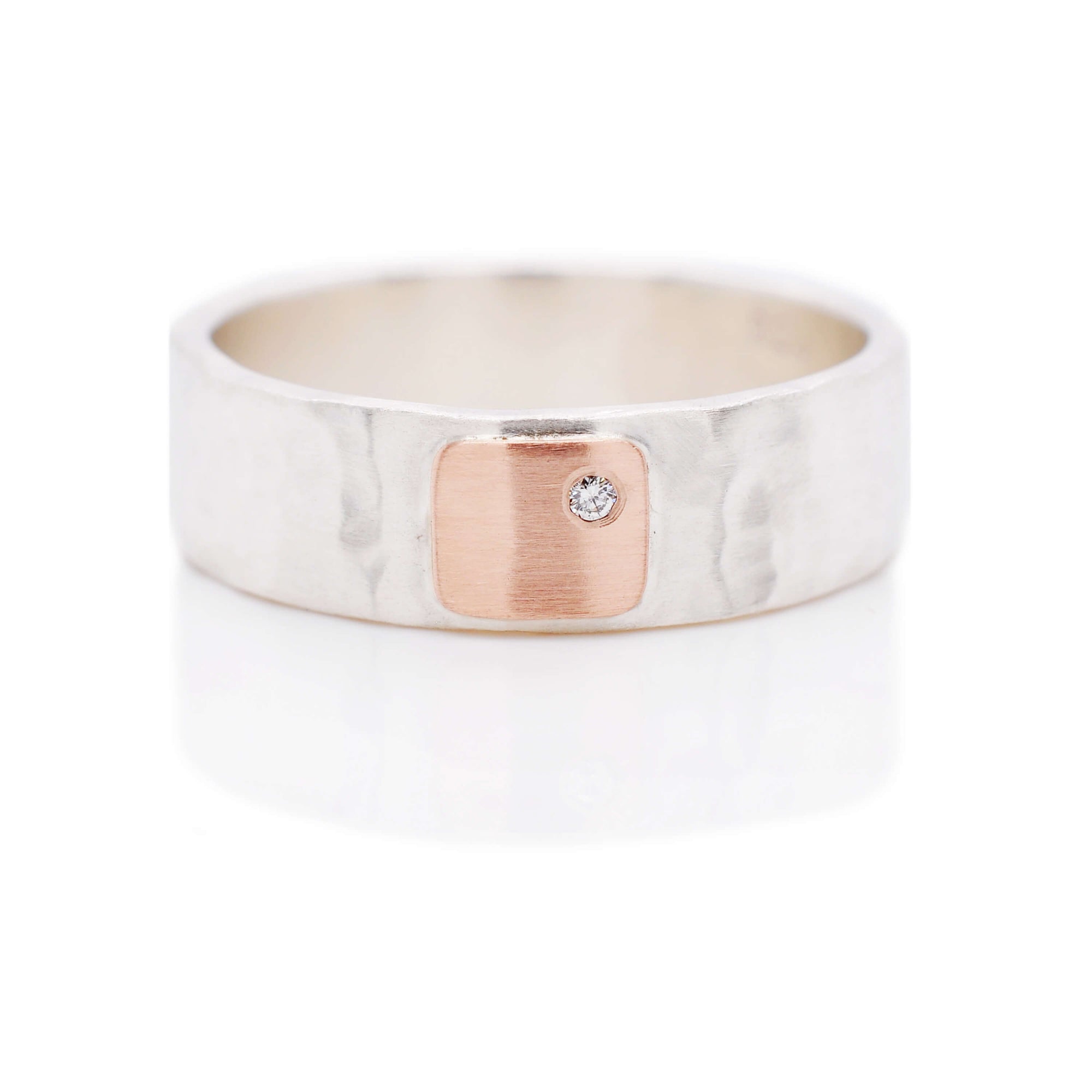 Hammered silver wedding band with rose gold and diamond accent. Handmade by EC Design Jewelry in Minneapolis, MN using recycled metal and conflict-free stone.