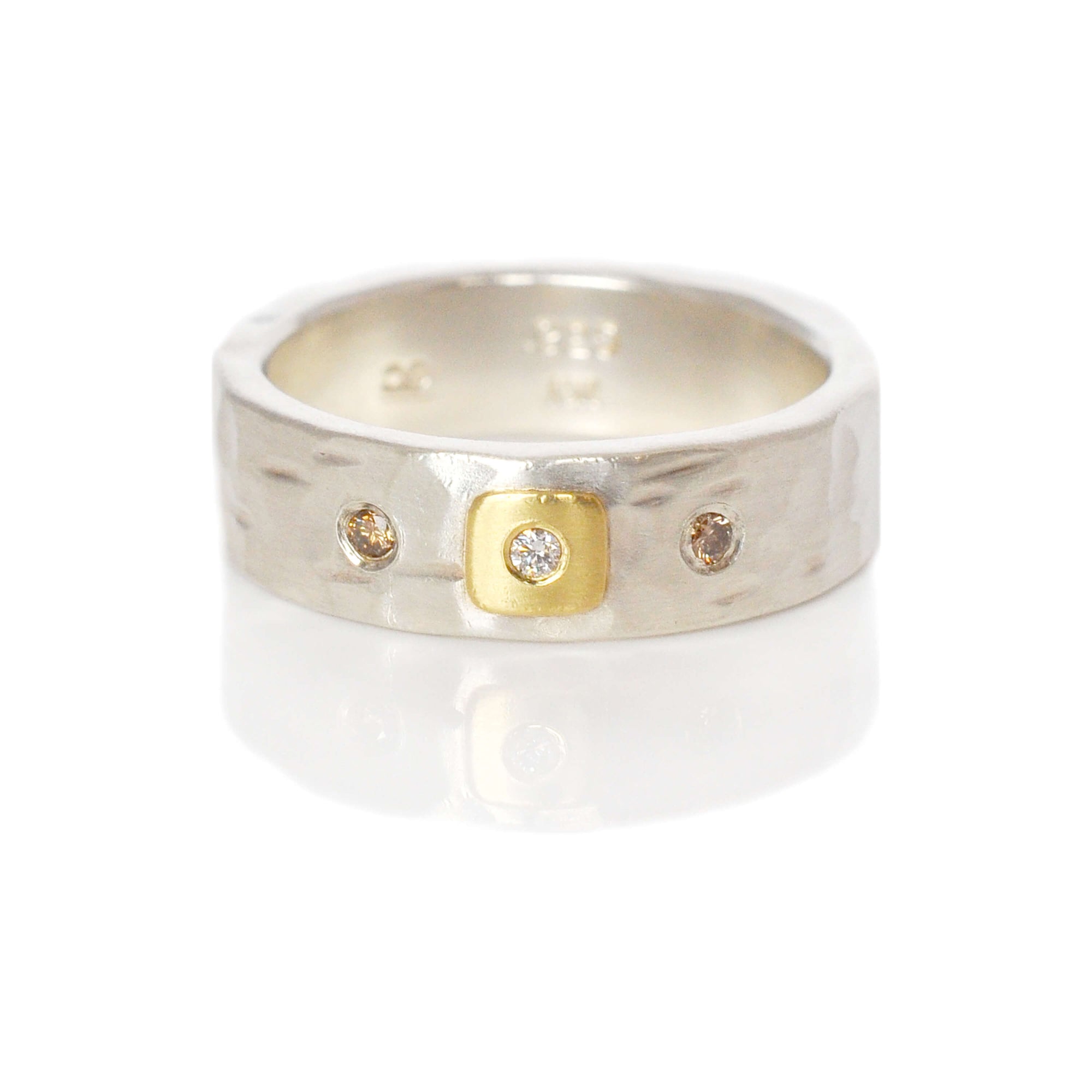 Sterling silver hammered band with yellow gold and diamond accents. Handmade by EC Design Jewelry in Minneapolis, MN.