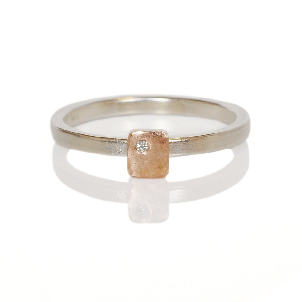 Sterling silver band with a red gold rectangle with a flush set white diamond. Ethically created by EC Design Jewelry in Minneapolis, MN.