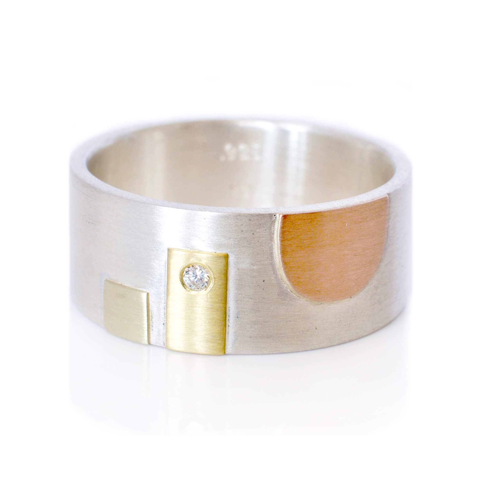 Sterling silver rivet band with rose gold, yellow gold, green gold, and diamond accent. Handmade with recycled metal and conflict-free stone. Designed and sold by EC Design Jewelry in Minneapolis, MN