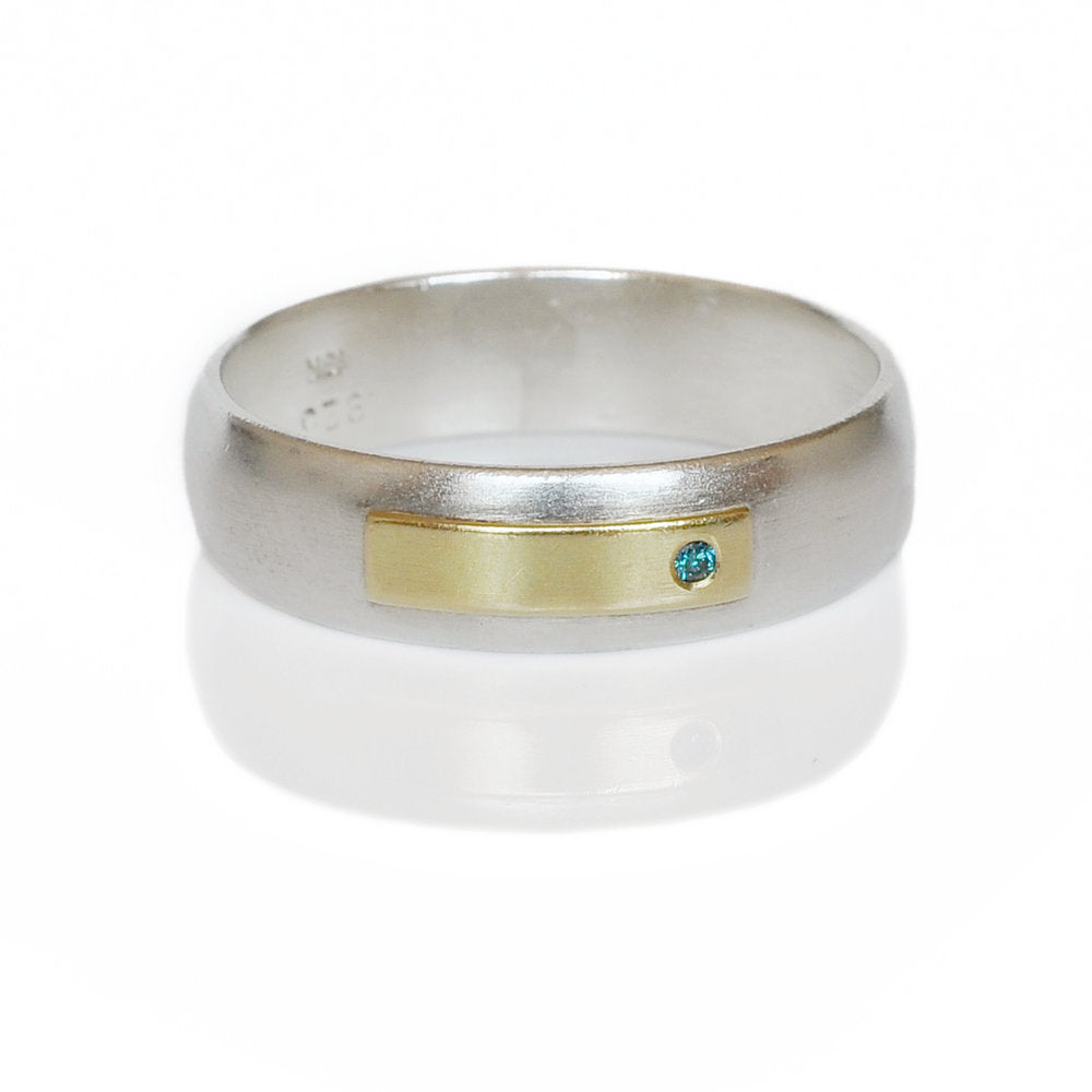 Sterling silver low dome band with yellow gold and blue diamond accent. Handmade by EC Design Jewelry in Minneapolis, MN using recycled metal and conflict-free stone.