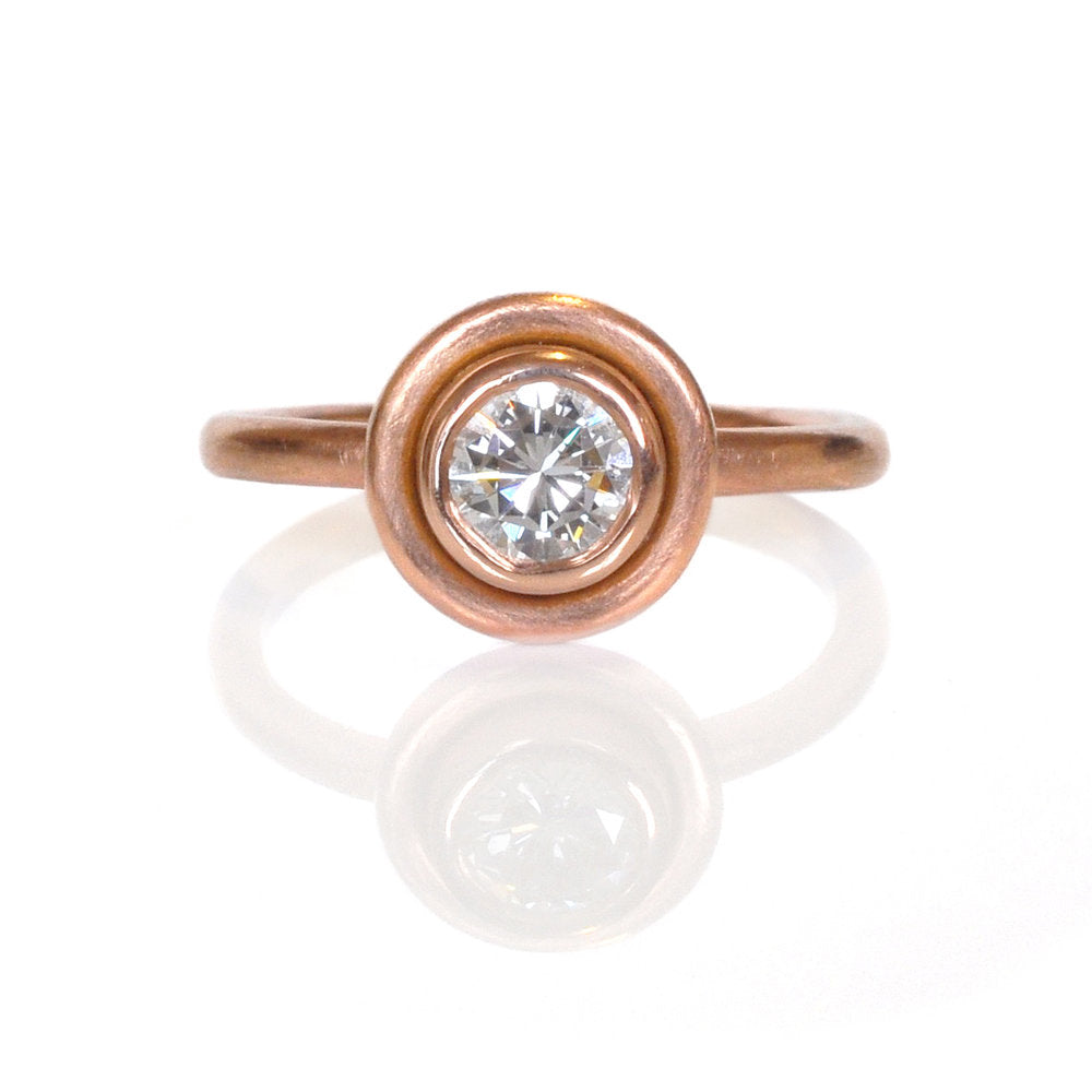 Saturn bezel set round brilliant diamond in rose gold. Handmade by EC Design Jewelry in Minneapolis, MN using recycled metal and conflict-free stone.