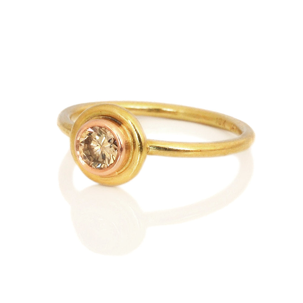 Champagne round brilliant diamond in a red gold Saturn bezel with a yellow gold halo. Handmade with recycled metal and conflict-free stone by EC Design Jewelry in Minneapolis, MN.