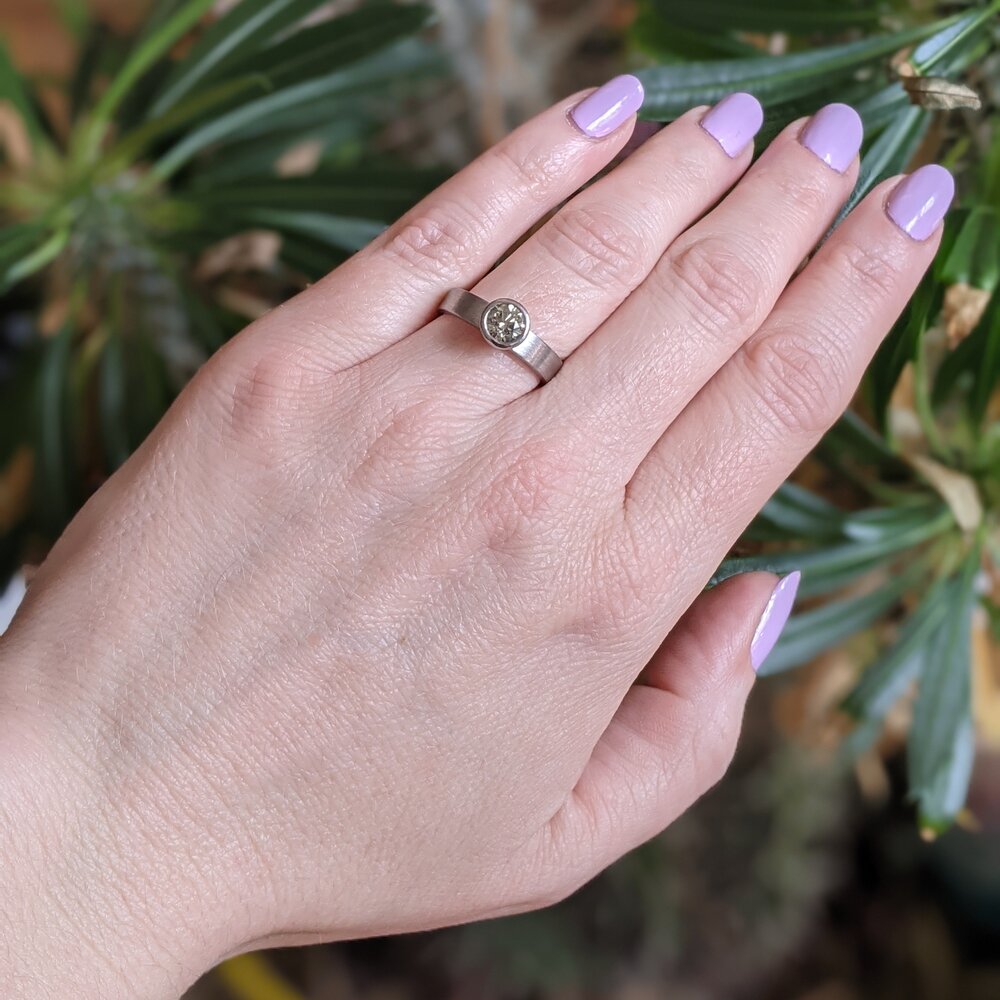 Modern engagement ring. Natural green brilliant cut diamond in palladium. Handmade by EC Design Studio in Minneapolis, MN using recycled metal and conflict-free stone.