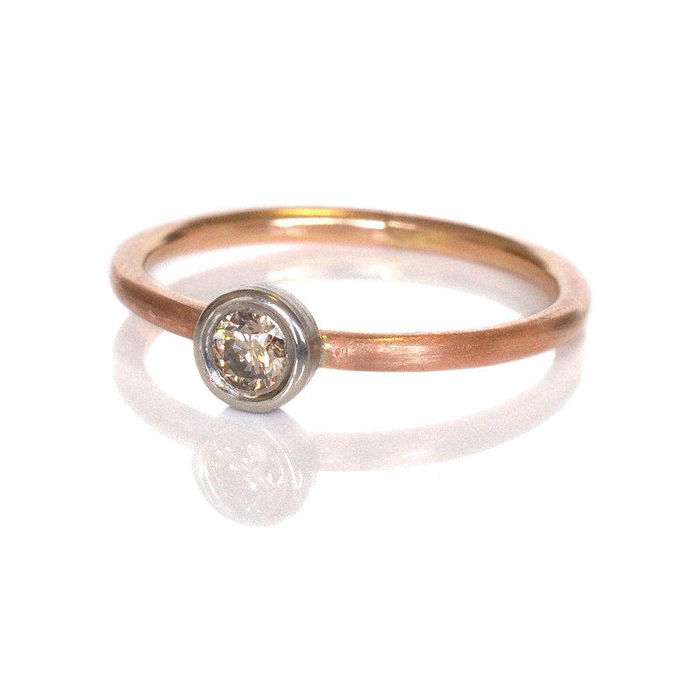 Round brilliant champagne diamond bezel set in palladium on a satin finished rose gold band. Handmade by EC Design Jewelry in Minneapolis, MN.