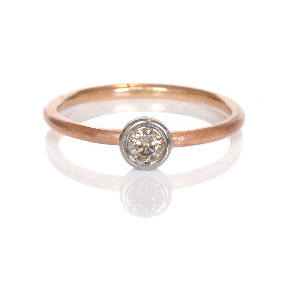 Round brilliant champagne diamond bezel set in palladium on a satin finished rose gold band. Handmade by EC Design Jewelry in Minneapolis, MN.