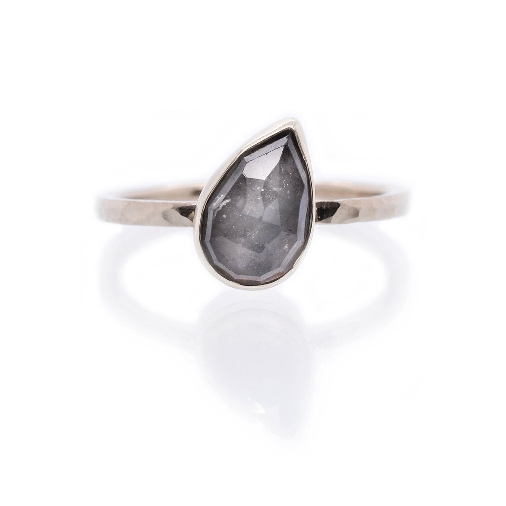 Tilted gray-blue pear shaped sapphire and palladium white gold engagement ring. Handmade with recycled metal and conflict-free stone. EC Design Jewelry in Minneapolis, MN.