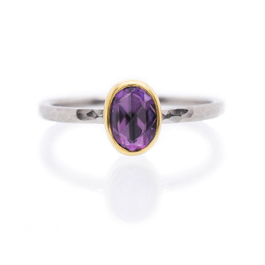 Purple Ceylon sapphire bezel set in yellow gold on a hammered palladium band. Handmade by EC Design Jewelry in Minneapolis, MN using recycled metal and conflict-free stone.