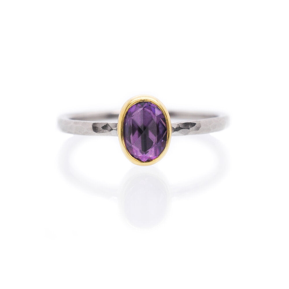 Purple Ceylon sapphire bezel set in yellow gold on a hammered palladium band. Handmade by EC Design Jewelry in Minneapolis, MN using recycled metal and conflict-free stone.