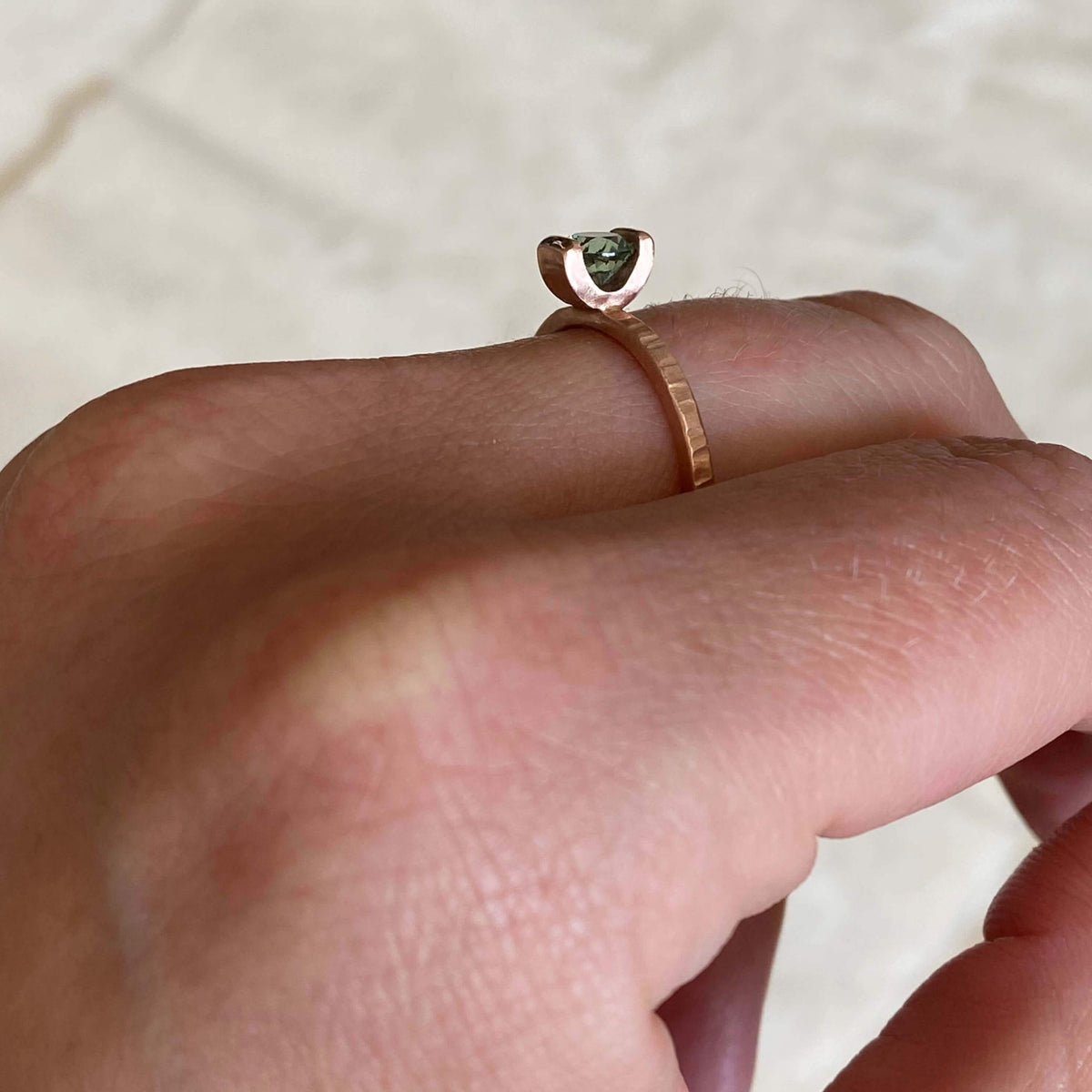 Teal Montana sapphire engagement ring in hammered red gold. Ethically handmade by EC Design Jewelry in Minneapolis, MN.