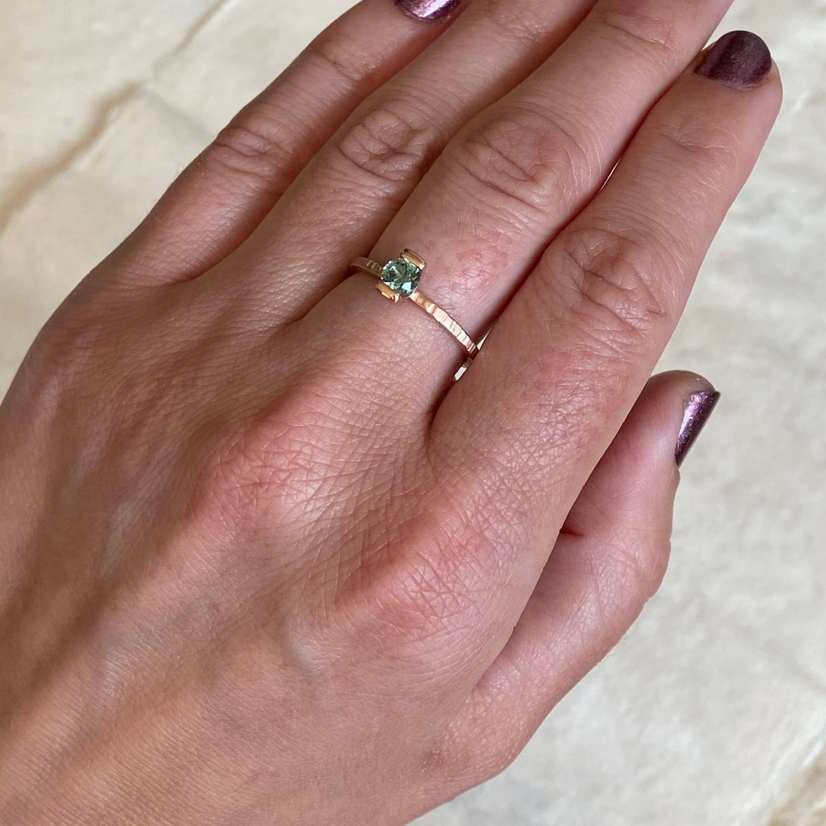 Teal Montana sapphire engagement ring in red gold. Ethically handmade by EC Design Jewelry in Minneapolis, MN.