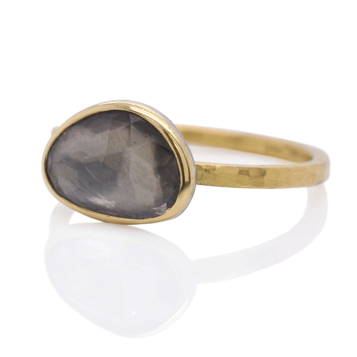 Gray rose cut sapphire solitaire with a hand hammered yellow gold band.