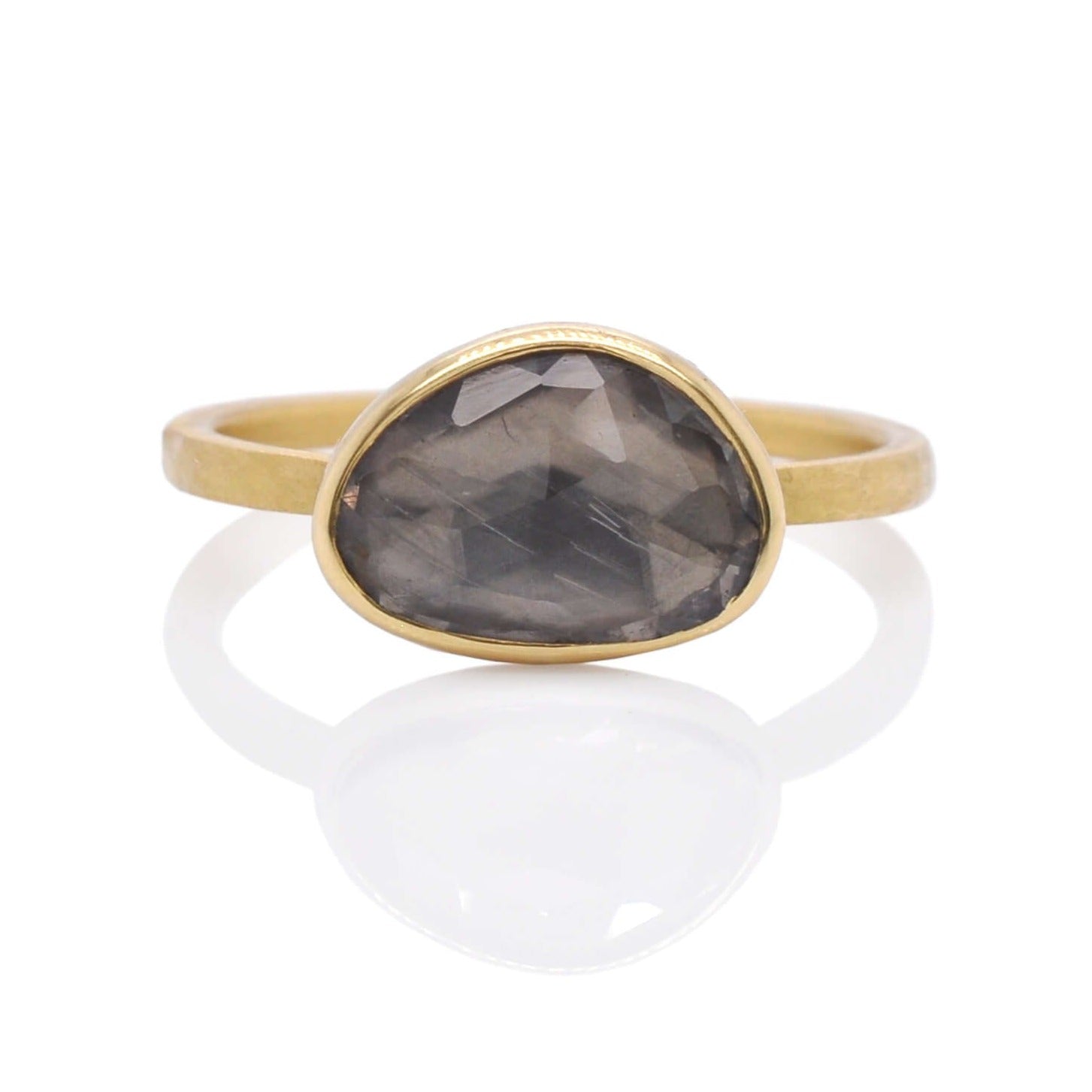 Organic shaped gray rose cut sapphire set in satin finished yellow gold.