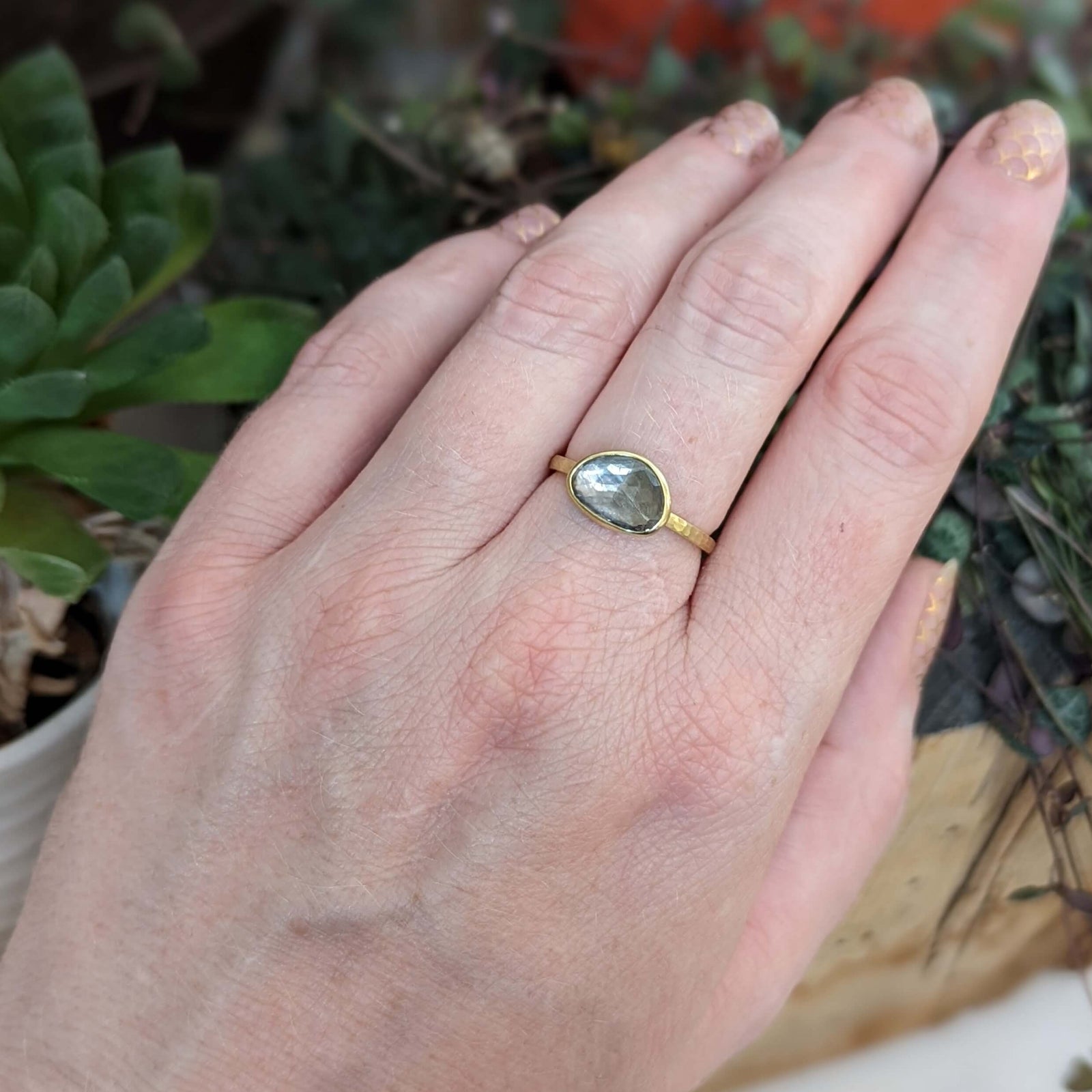 Organic shaped gray rose cut sapphire set in satin finished yellow gold.