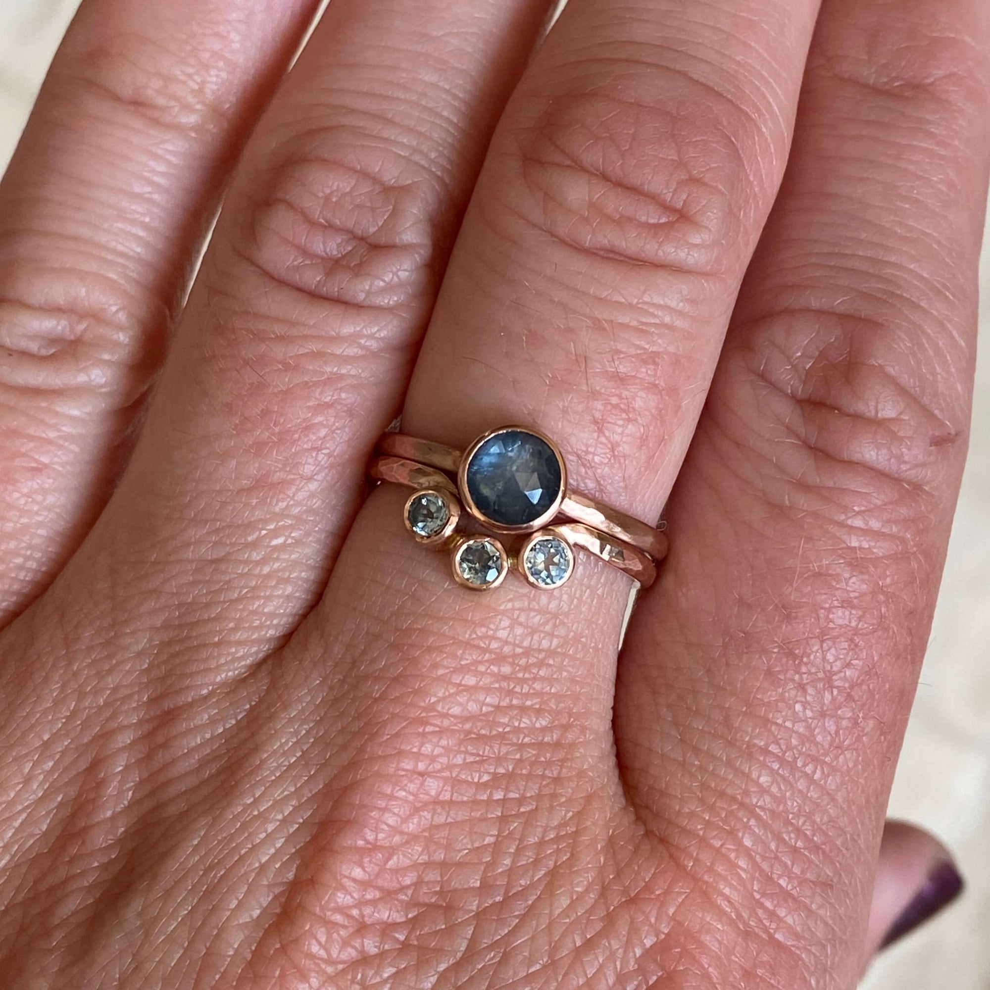 Blue sapphire and rose gold contour band from EC Design Jewelry in Minneapolis, MN. Made with recycled metal and conflict-free stones.
