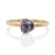 Purple trillion cut sapphire solitaire in hammered yellow gold.