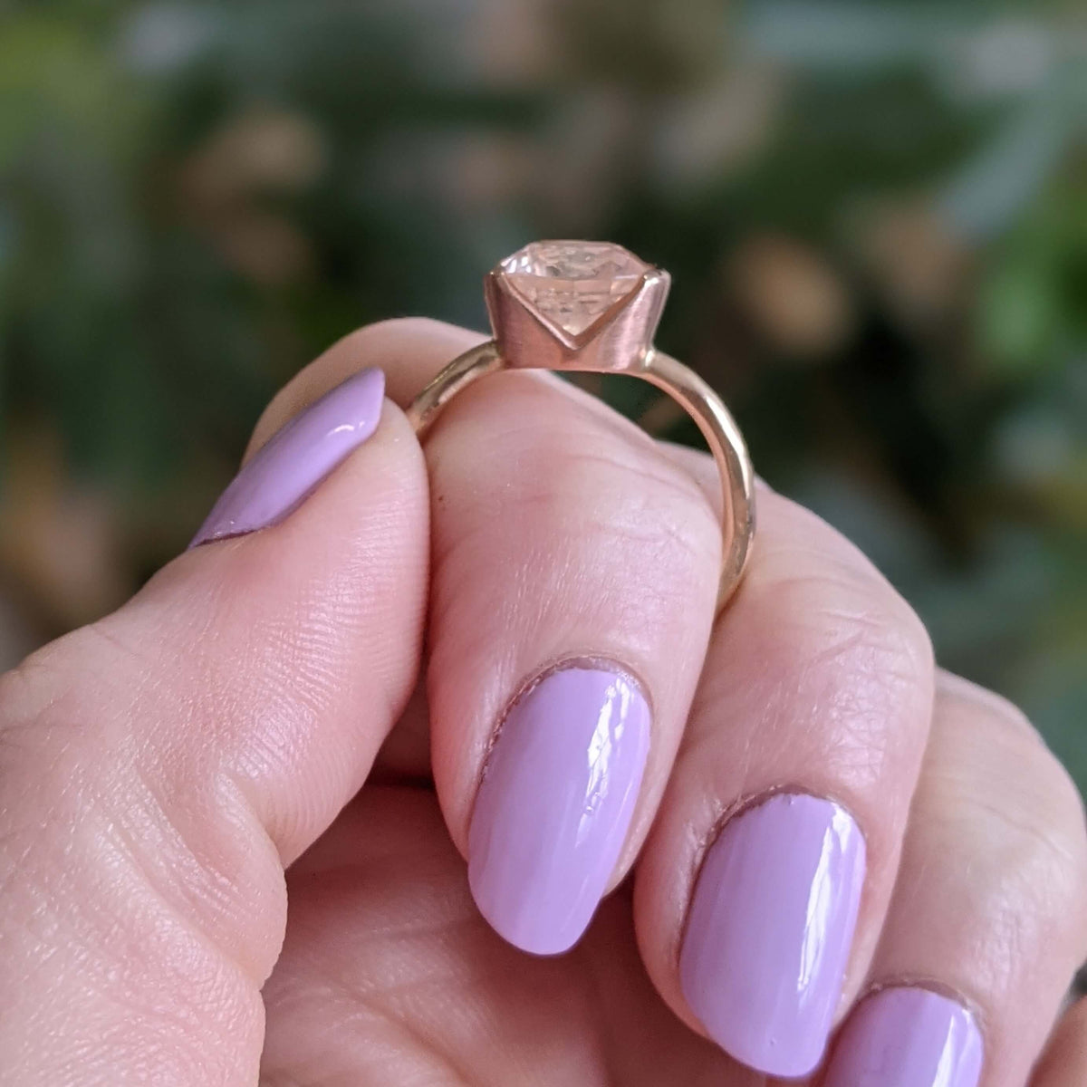Peach sapphire set in yellow and red gold. Handmade by EC Design Jewelry in Minneapolis, MN using recycled metal and conflict-free stone.