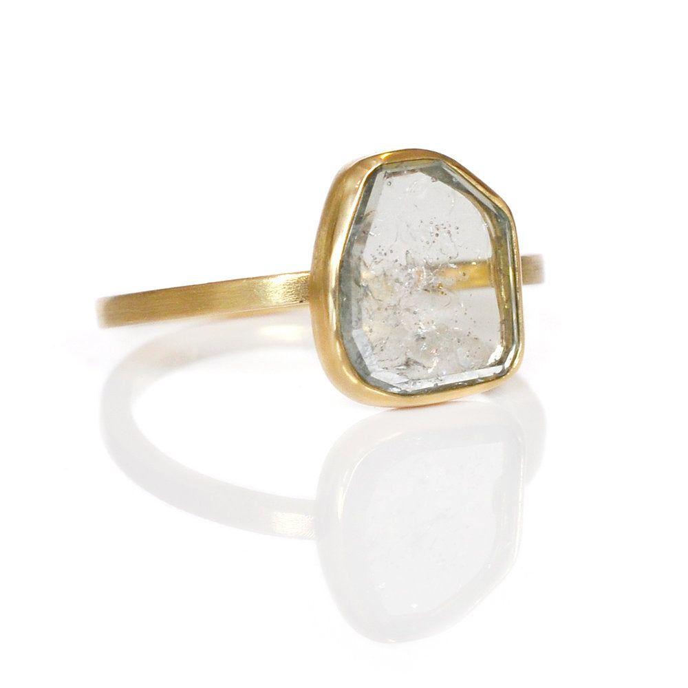 Sapphire slice ring with open back bezel in yellow gold. Handmade by EC Design Jewelry in Minneapolis, MN.