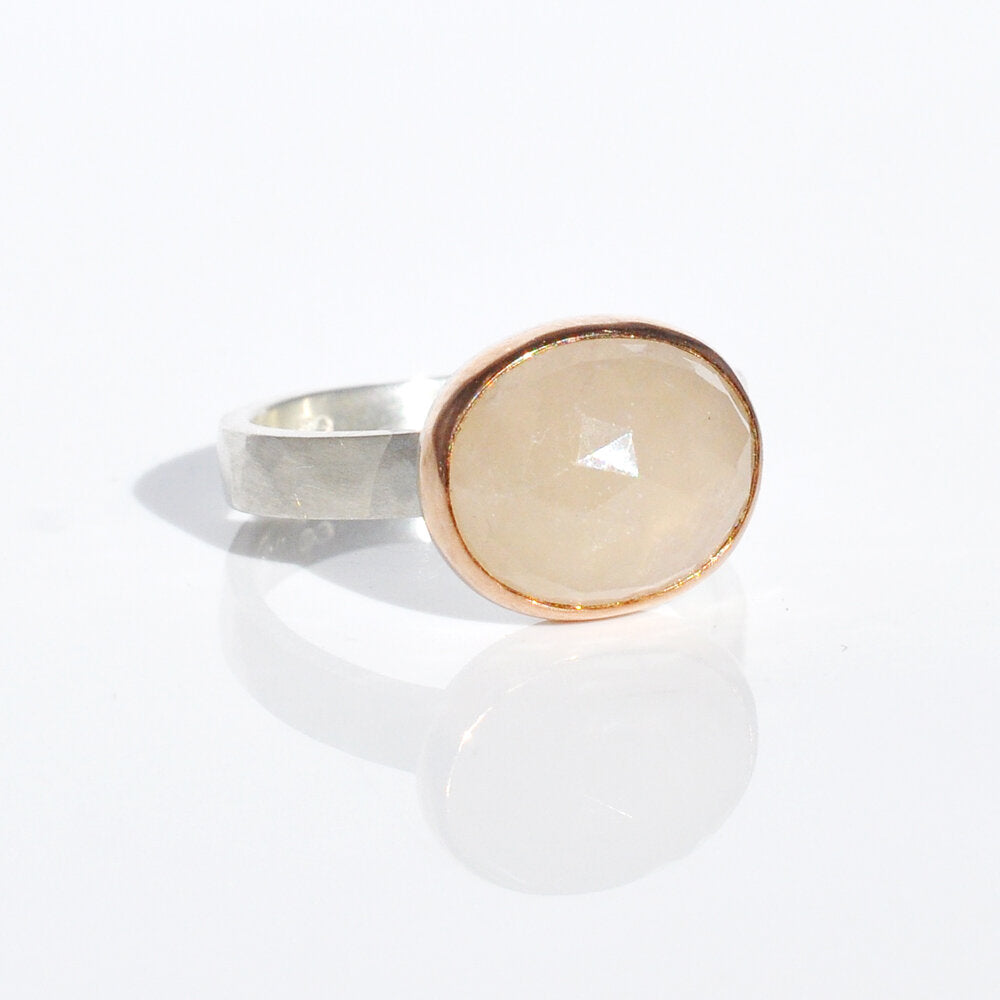 Cream colored rose cut sapphire bezel set in rose gold on a hammered band of sterling silver. Handmade by EC Design Jewelry in Minneapolis, MN.