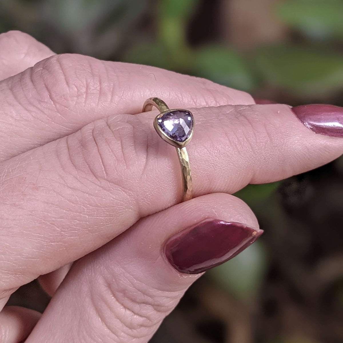 Trillion cut sapphire solitaire in yellow gold.