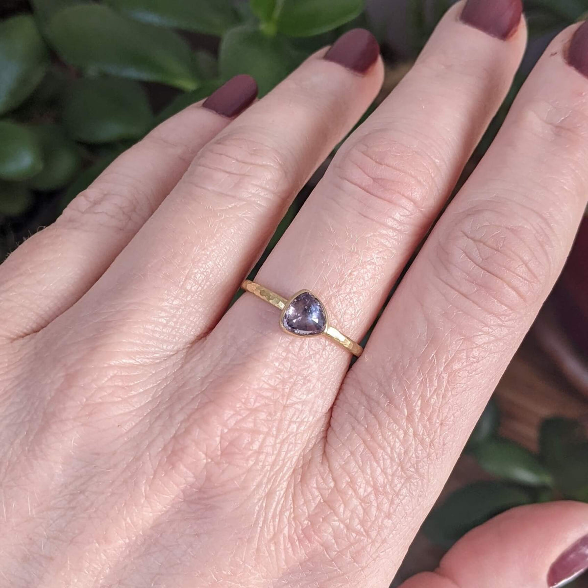 Purple trillion cut sapphire solitaire in yellow gold. Handmade by EC Design Jewelry in Minneapolis, MN.