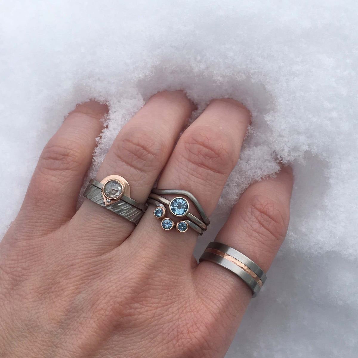 Handmade diamond and sapphire rings in palladium and rose gold. Made by EC Design Jewelry in Minneapolis, MN.